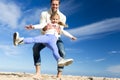 Father Swinging Daughter on Beach