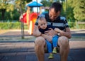 Father swinging with his baby boy Royalty Free Stock Photo