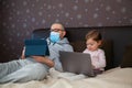 Father with tablet, daughter with laptop