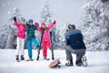 father take photographing family on winter vacation in snow mountains Royalty Free Stock Photo