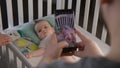 Father takes a picture or video of baby using smartphone Royalty Free Stock Photo