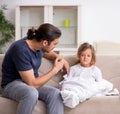 Father taking care of his ill daughter Royalty Free Stock Photo