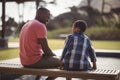 Father talking to son near pool side