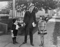 Father talking to two children outside