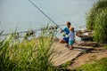 Father teach small son to fish in freshwater Royalty Free Stock Photo
