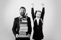 Father or teacher hold big stack school textbook notebook books. Happy excited preteen girl wears school uniform holding Royalty Free Stock Photo