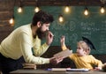 Father, teacher reading book, teaching kid, son, chalkboard on background. Dad wants to grow up genius son. Boy child in