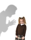 Father or teacher shadow screaming angry reproving young sweet little schoolgirl or daughter