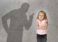 Father or teacher shadow screaming angry reproving young sweet little schoolgirl or daughter Royalty Free Stock Photo
