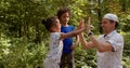 Father teaches children playing with hands. Lifestyle, outdoor. Patty Cake game. Royalty Free Stock Photo