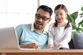 Father teaches cute girl daughter to do school homework, using laptop computer for e-learning study at home, happy family dad and Royalty Free Stock Photo