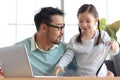 Father teaches cute girl daughter to do school homework, using laptop computer for e-learning study at home, happy family dad and Royalty Free Stock Photo