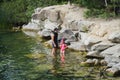 A father teaches his little daughter to snorkel on a lake on a summer day Royalty Free Stock Photo