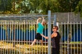 The father teaches his son to pull up on the bar in the summer