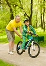 Father teaches his son to ride a bike Royalty Free Stock Photo