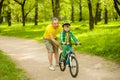 Father teaches his son to ride a bike