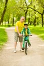 Father teaches his son to ride a bike Royalty Free Stock Photo