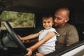 Father teaches little son to drive on road trip Royalty Free Stock Photo