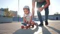 father teaches son baby to ride children skateboard. happy family kid dream concept. baby baby rides skateboard dad Royalty Free Stock Photo