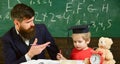 Father teaches son, discuss, explain. Education concept. Kid studying with teacher. Elementary education. Teacher in