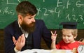 Father teaches son mathematics. Cheerful kid studying with teacher. Arithmetic lesson concept. Teacher in formal wear Royalty Free Stock Photo