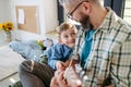 Father teaching boy to play on acoustic guitar. Mesmerized son listening dad making music. Concept of Fathers Day and