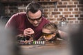 Father teaching daughter to braze concentrated process