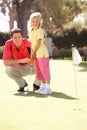 Father Teaching Daughter To Play Golf