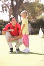 Father Teaching Daughter To Play Golf Royalty Free Stock Photo