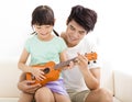 Father Teaching daughter To Play ukulele Royalty Free Stock Photo