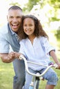 Father Teaching Daughter To Ride Bike In Park Royalty Free Stock Photo