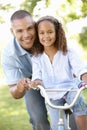 Father Teaching Daughter To Ride Bike In Park Royalty Free Stock Photo