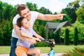 Father teaching daughter to ride a bike Royalty Free Stock Photo