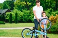 Father teaching daughter to ride a bike Royalty Free Stock Photo