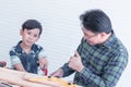 Father is teaching his boy to work on construction woodwork tools Royalty Free Stock Photo