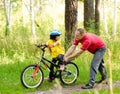 Father teaching his daughter to ride a bike Royalty Free Stock Photo