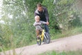 Father teaching his little child to ride bike in spring summer park. Boy learning to ride bicycle. Happy family moments. Time Royalty Free Stock Photo