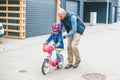 Father teaching his little daughter to ride a bicycle Royalty Free Stock Photo