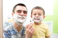 Father teaching his son boy how to shave