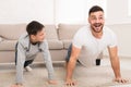 Father teaching his son doing push-ups exercises Royalty Free Stock Photo