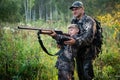 Father teaching his son about gun safety and proper use on hunting in nature. Royalty Free Stock Photo