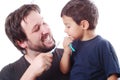 Father teaching his son how to clean the teeth Royalty Free Stock Photo