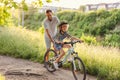 Father teaching his son how to ride a bicycle Royalty Free Stock Photo