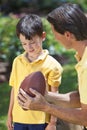 Father Teaching His Son To Play American Football