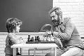 Father teaching his son to play chess. Chess strategy. Chess success and winning. Education and people concept. Happy