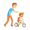 Father teaching his son to ride a bicycle Royalty Free Stock Photo