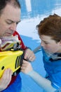 Father teaching his son to use fins