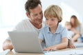 Father teaching his son using laptop Royalty Free Stock Photo