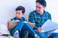 Father teaching his son about wood work and house renovation construction skill for parenting and famiyl bonding concept