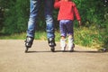 Father teaching little daugther to roller skate